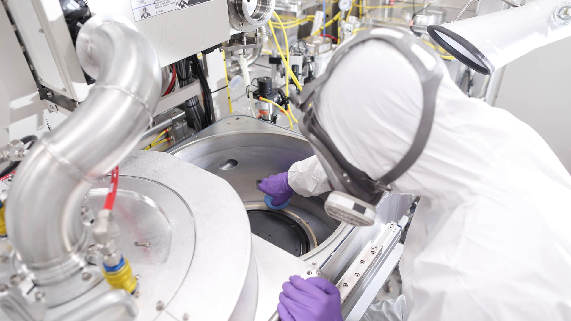 A BELFOR employee cleans the inside of a machine