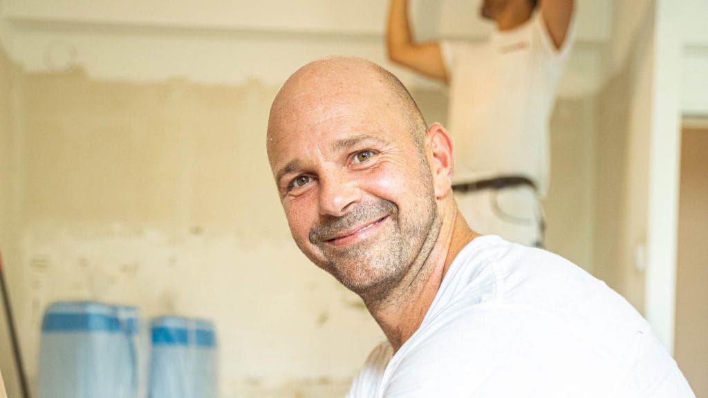 A male craftsman smiling