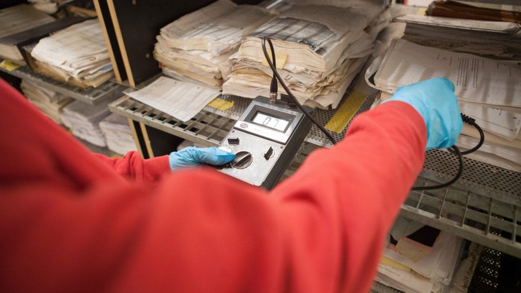 An employee testing out a device while wearing surgical gloves