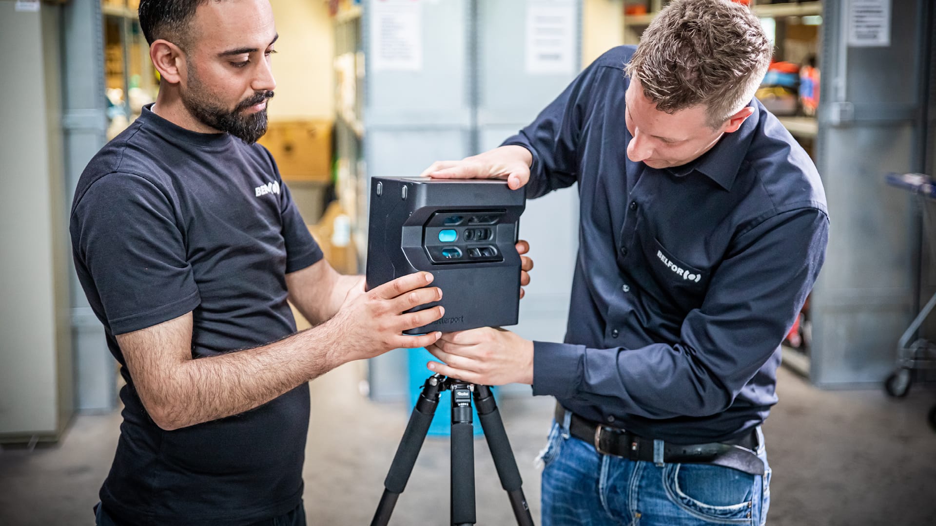 Two BELFOR employees setting up a device