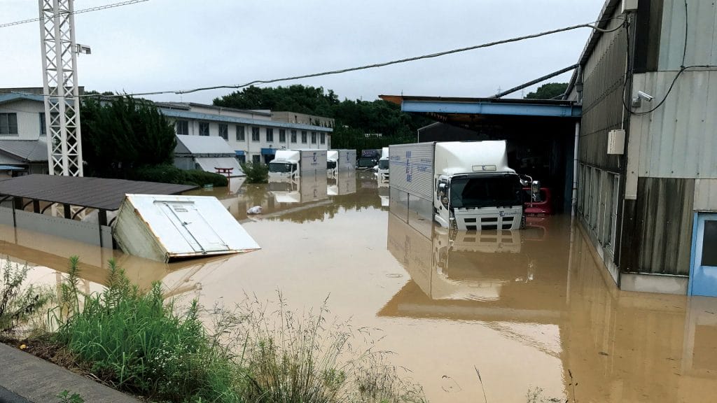 A flooded street with a truck