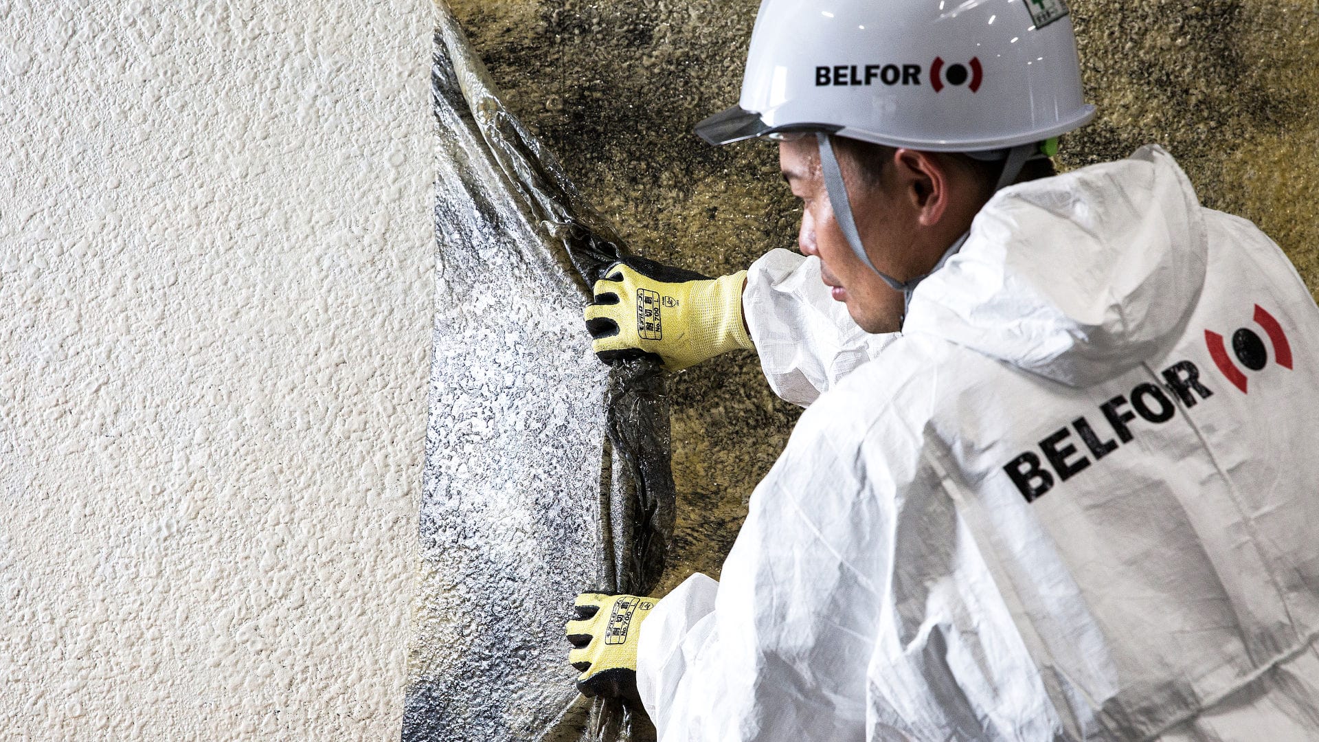 BELFOR Asia employee taking off soot removal film