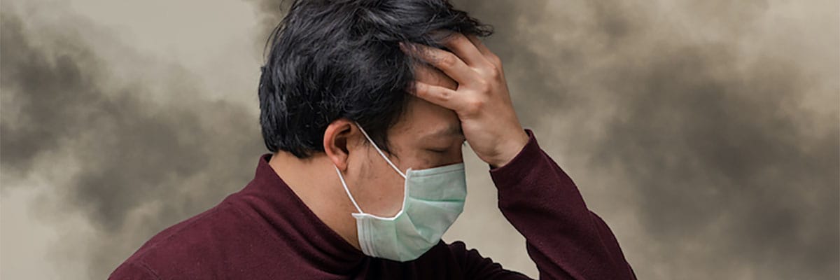 Asian man wearing the face mask against air pollution with cough