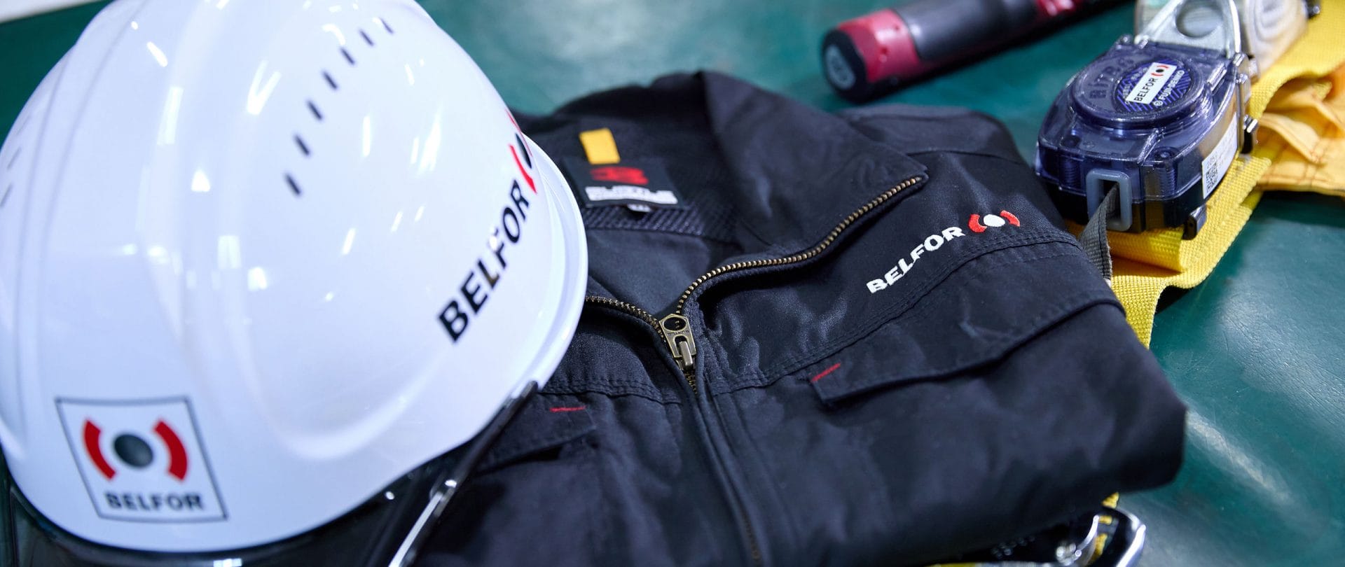 BELFOR helmet and suit on a table