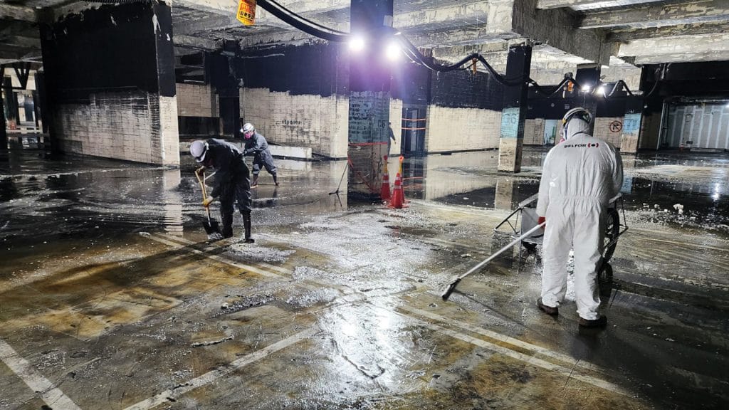 BELFOR employees cleaning a parking garage