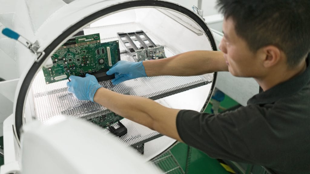 An employee assessing a motherboard