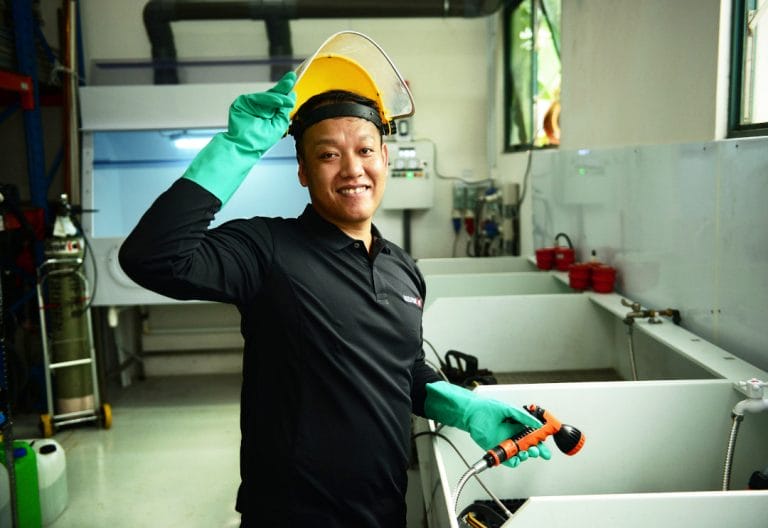 A BELFOR employee infront of a dipping bath line