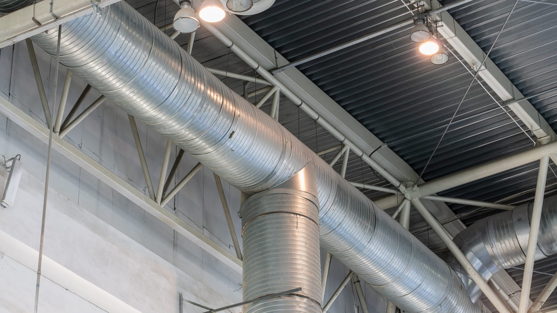 Industrial airducts running along the ceiling of a commercial building showcasing a complex ventilation system