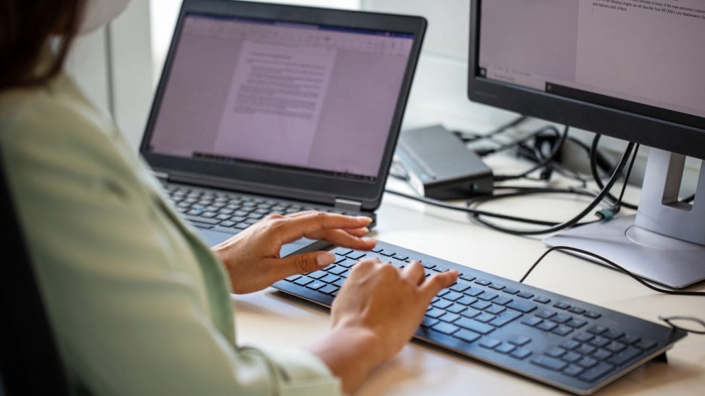 Woman in front of a PC typing