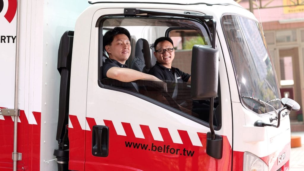 BELFOR employees sitting in recovery truck smiling to the camera