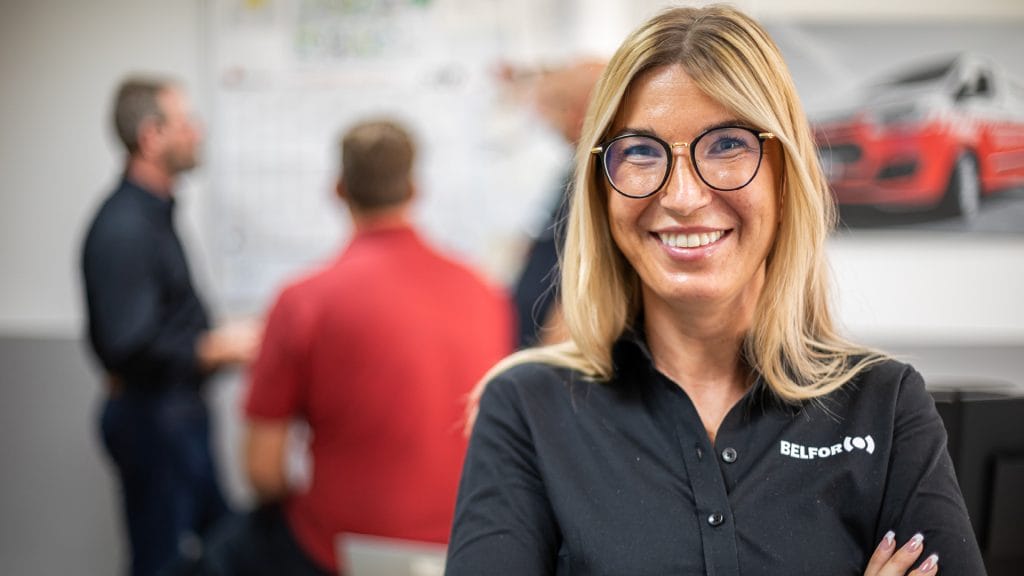 A female BELFOR employee smiling