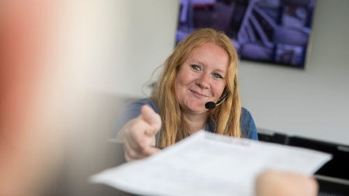 A female employee reaching out to get a folder