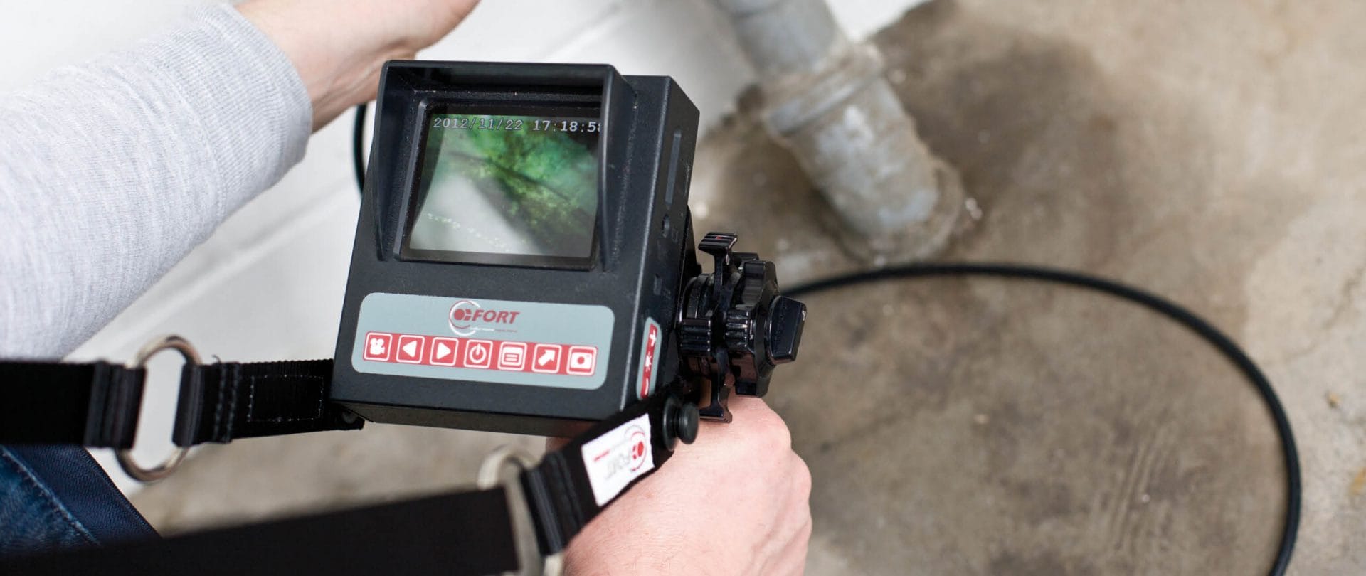 An employee using a device to find a leakage