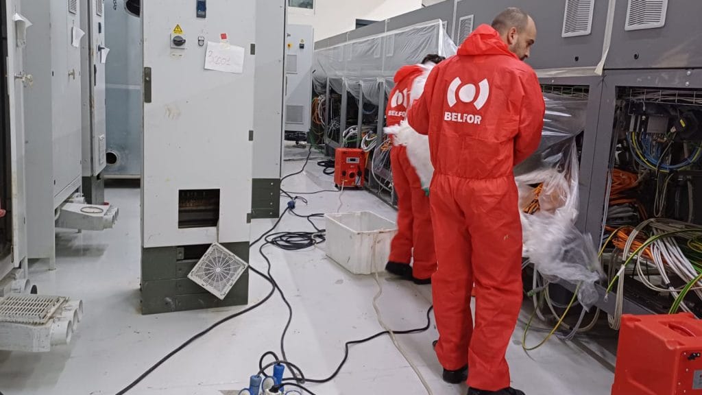 Two BELFOR employees inspecting wires