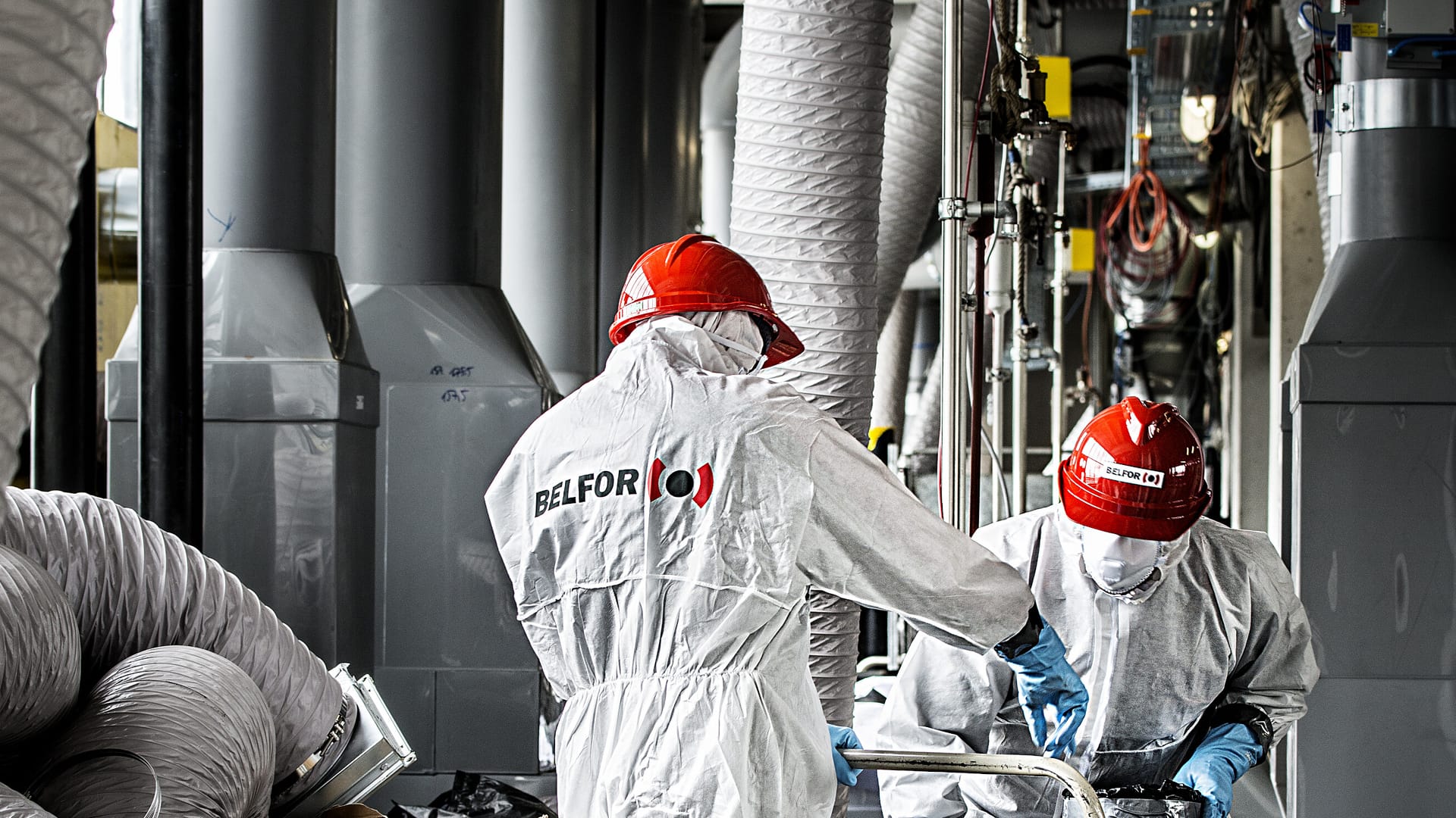 Two BELFOR employees wearing PPE suits and hard hats