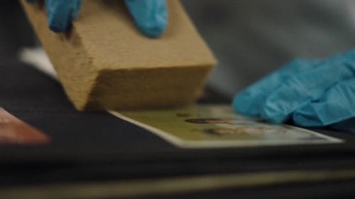 BELFOR Commercial - Anthem - Close up of a BELFOR worker restoring a family photo