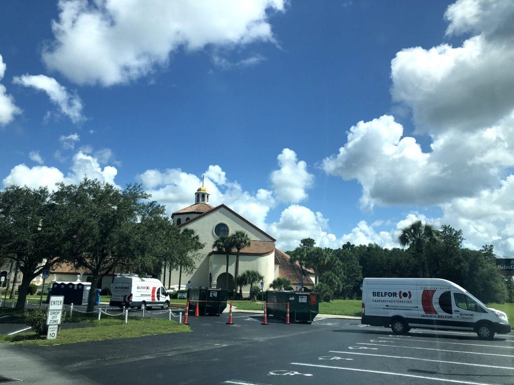 A BELFOR van parked near a church