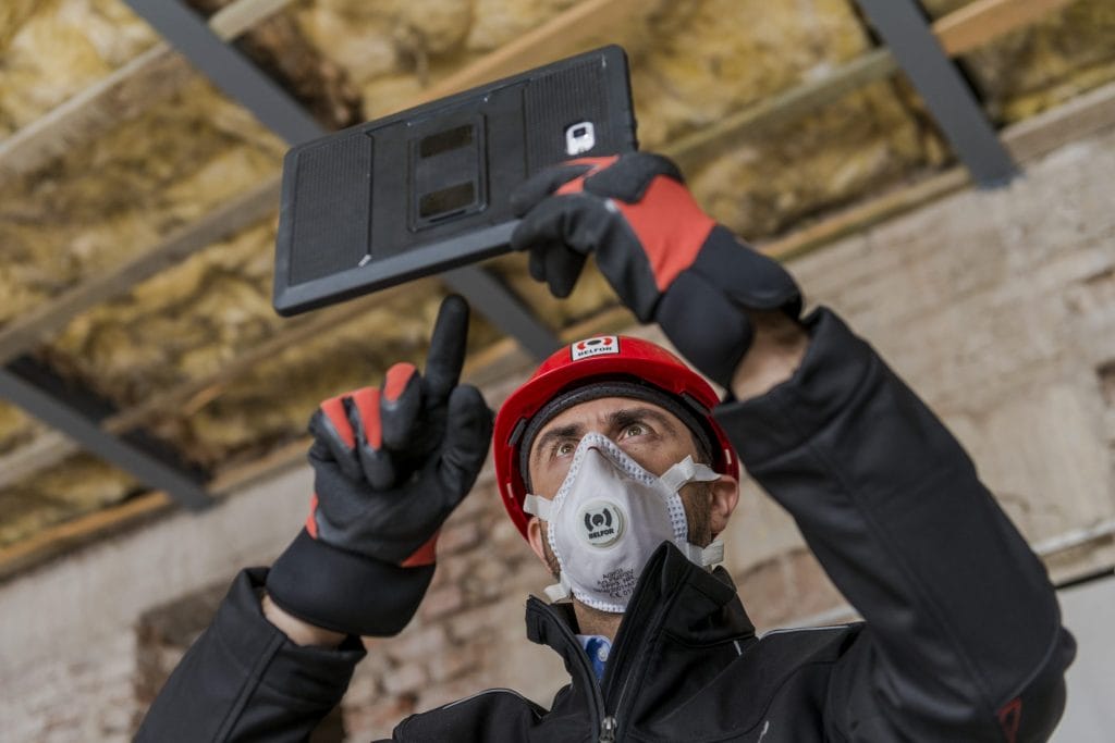 A BELFOR employee holding a tablet