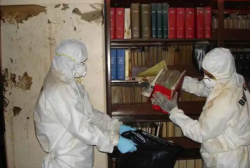 Belfor team examines books with mold