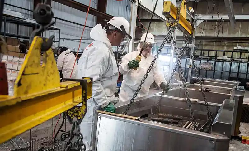 BELFOR employees repairing a machine