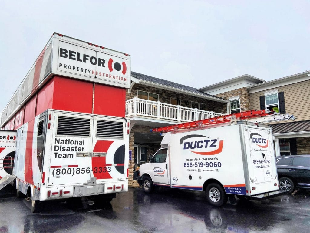 BELFOR vehicles in front of a senior living facility