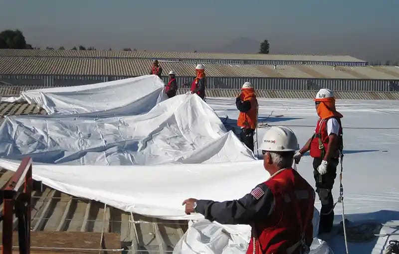 BELFOR employees performing shrink wrapping