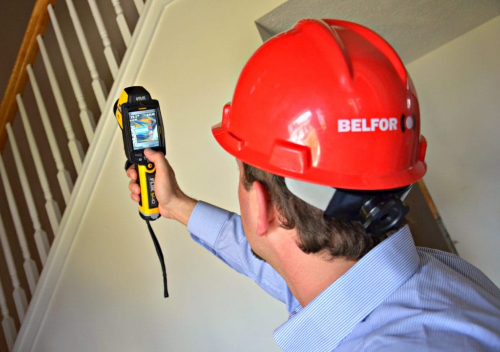 A BELFOR employee wearing a hard hat