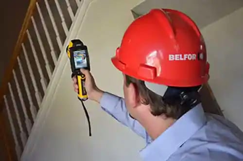 A Belfor expert using an IR camera