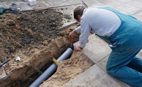 A worker checking the sewage canal​